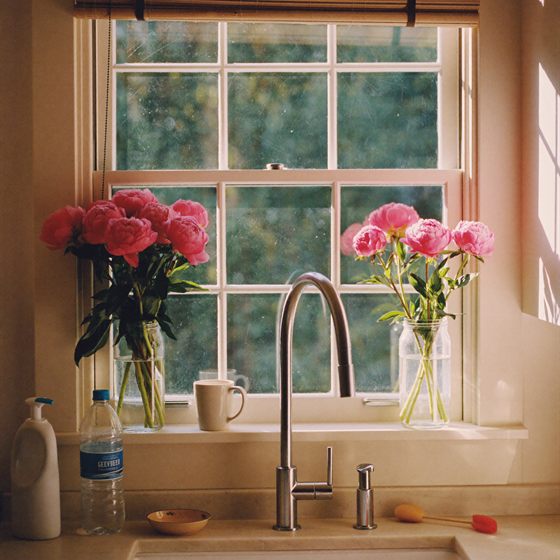 Library photo: pink peonies on a kitchen windowsill